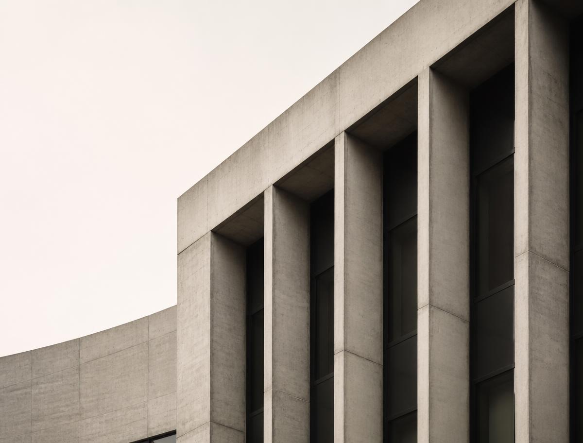 Concrete institutional facade under soft daylight